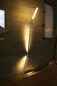 Minimalist floor lamp that leans against wall. Dimmable LED 